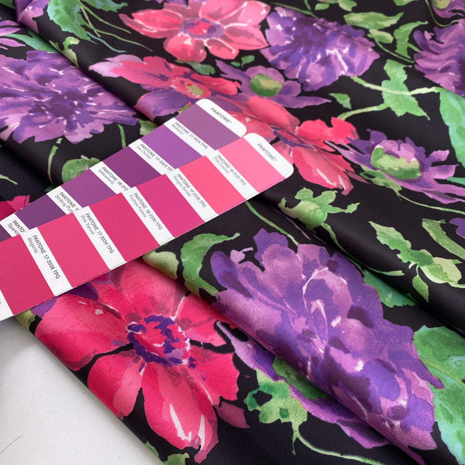 Polyester twill with beautiful flower design. The ground is black and the shades of the flowers are violet, hot pink an,d green. Very soft, light, and flowy. High-quality deadstock fabric by the meter collected in Stock from a Maison de Couture in Italy.