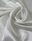 Soft and flowy white polyester cady with a shiny face and matte back. Not transparent, ideal for dresses, skirts, and trousers.High-quality deadstock collected in Stock from a Maison de Couture in Italy.