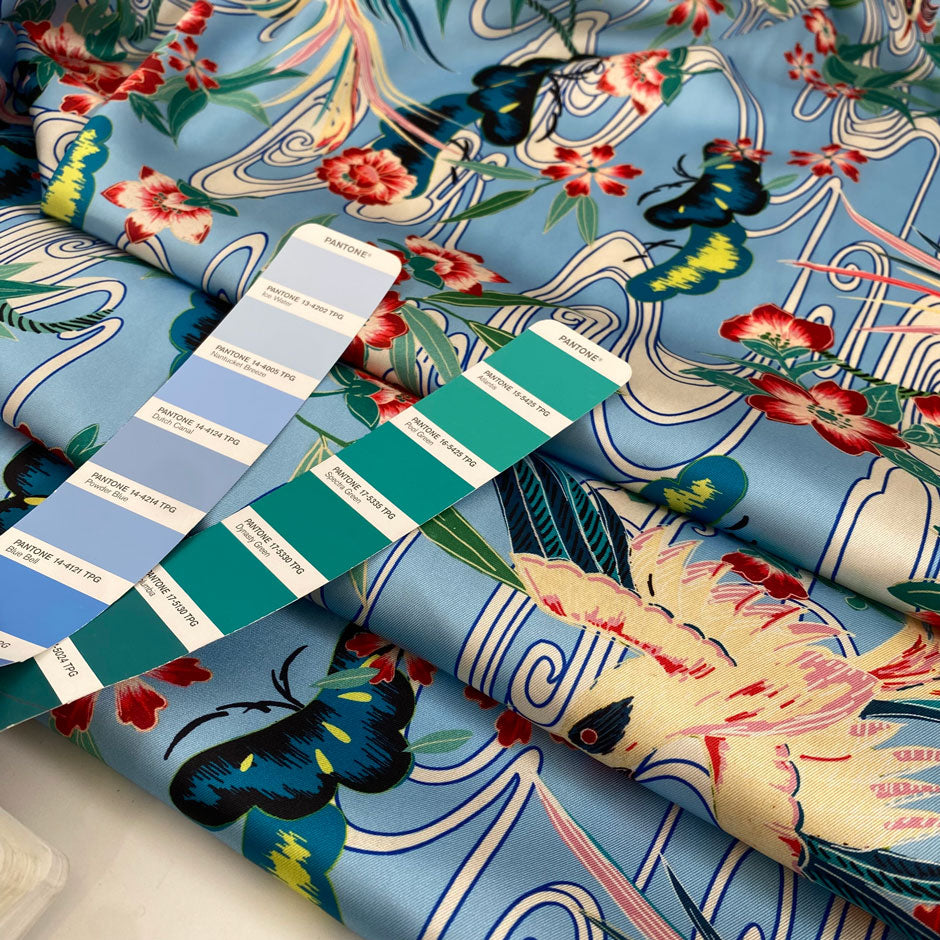 Polyester satin with floral design in the shades of blue, white, light blue, green and red. Very soft, light and flowy. High-quality deadstock fabric collected in Stock from a Maison de Couture in Italy.