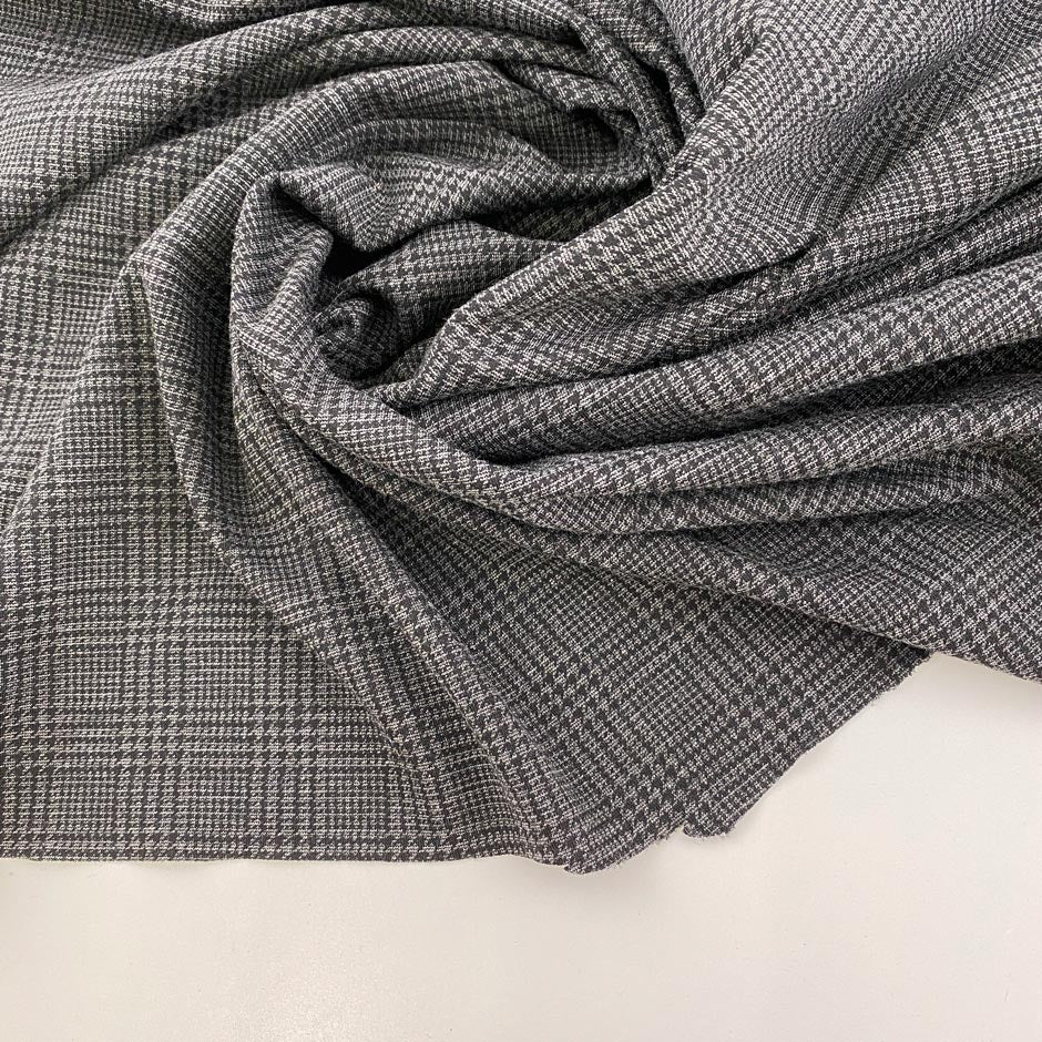 Gray jersey of viscose Punto Milano printed Prince of Wales. High-quality deadstock fabric collected in Stock from a Maison de Couture in Italy.