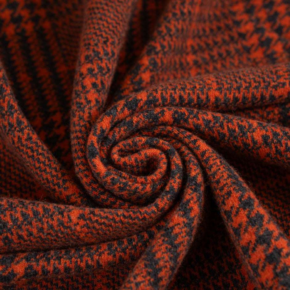 Prince of Wales knit of pure orange wool. The fabric is soft and strecthy. High quality deadstock fabric.