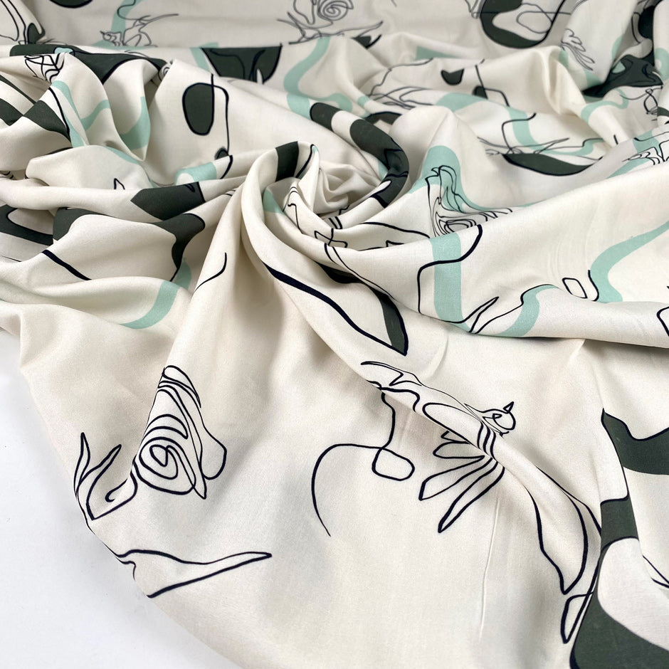 Pure viscose with a beautiful minimal design. The ground is light vanilla and the print is in the shades of green and black. The fabric is very soft and light. High-quality deadstock fabric collected in Stock from a Maison de Couture in Italy.