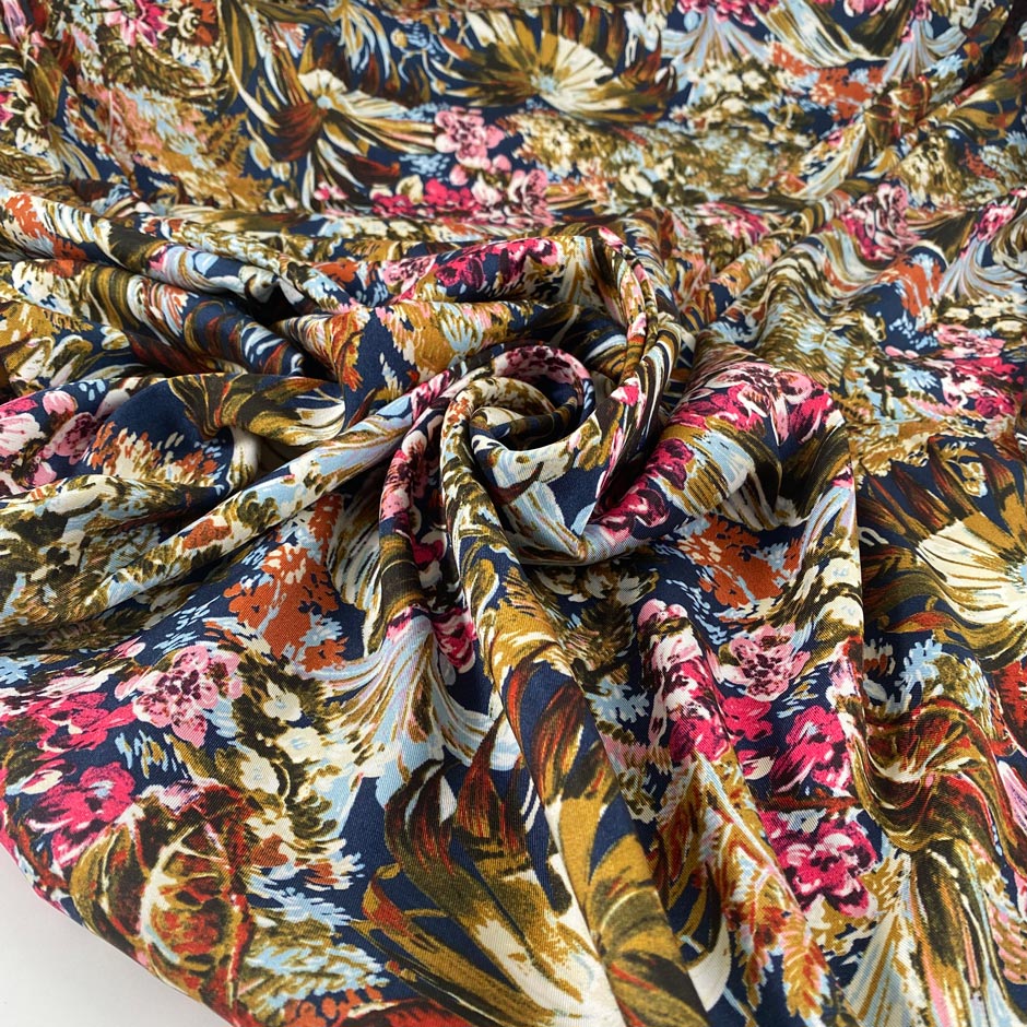 Multicolor polyester twill with beautiful floral design. In dark blue background and red, green, pink, light blue and white shades. Very light high-quality deadstock fabric by the meter collected in Stock from a Maison de Couture in Italy.