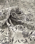 Pure silk with white ground and the flower design is in shades of gray. Very light, soft and semitrasparent. High-quality deadstock fabric collected in Stock from a Maison de Couture in Italy.