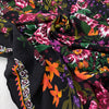 Pure viscose with floral design in panels. The ground is black and the print is in the shades of green, orange, dark red, and fuchsia. Very soft, light, and flowy. Ideal for dresses, skirts, and blouses. High-quality deadstock collected in Stock from a Maison de Couture in Italy.