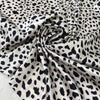 Polyester satin with stretch in black and white animal print. Shiny, very soft and light, flowy and not transparent. Ideal for dresses, skirts, blouses, and shirting. High-quality deadstock collected in Stock from a Maison de Couture in Italy.