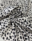 Polyester satin with stretch in black and white animal print. Shiny, very soft and light, flowy and not transparent. Ideal for dresses, skirts, blouses, and shirting. High-quality deadstock collected in Stock from a Maison de Couture in Italy.