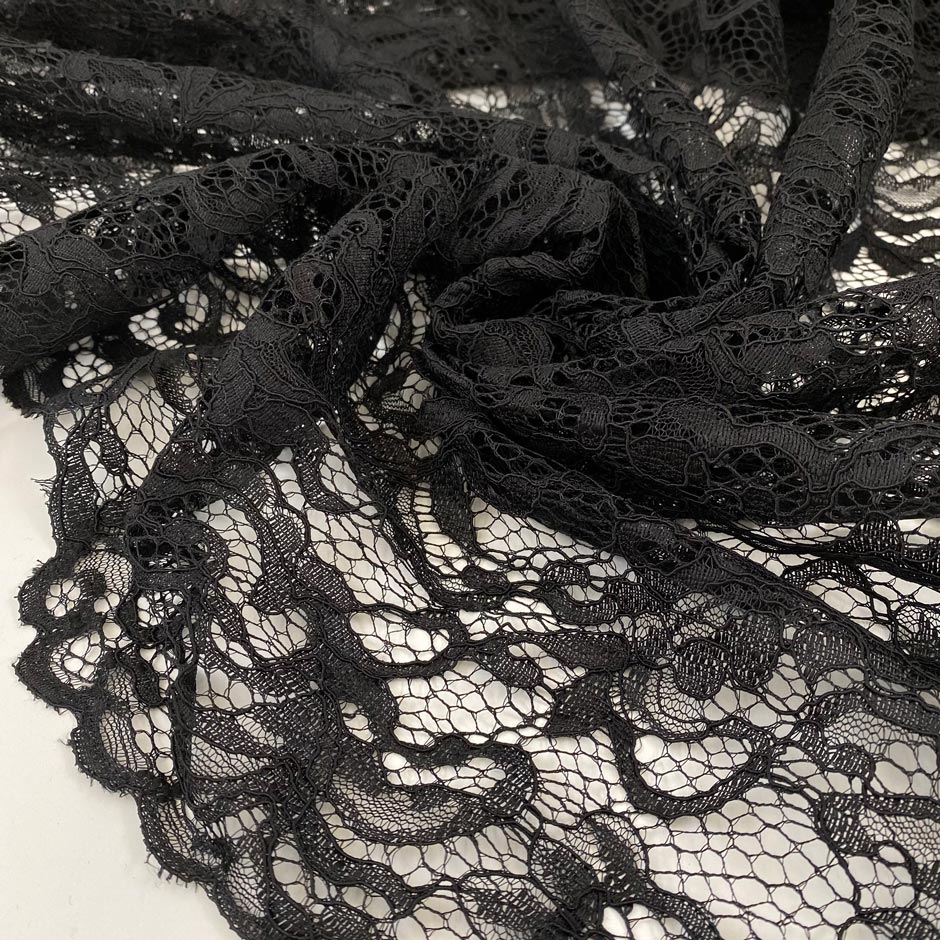 Polyester lace rebordè in black with double scalloped, soft and light. High-quality deadstock fabric collected in Stock from a Maison de Couture in Italy.