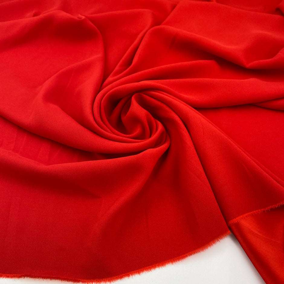 Soft, stretch viscose cady in red. High quality deadstock fabric collected in Stock from a Maison de Couture in Italy.