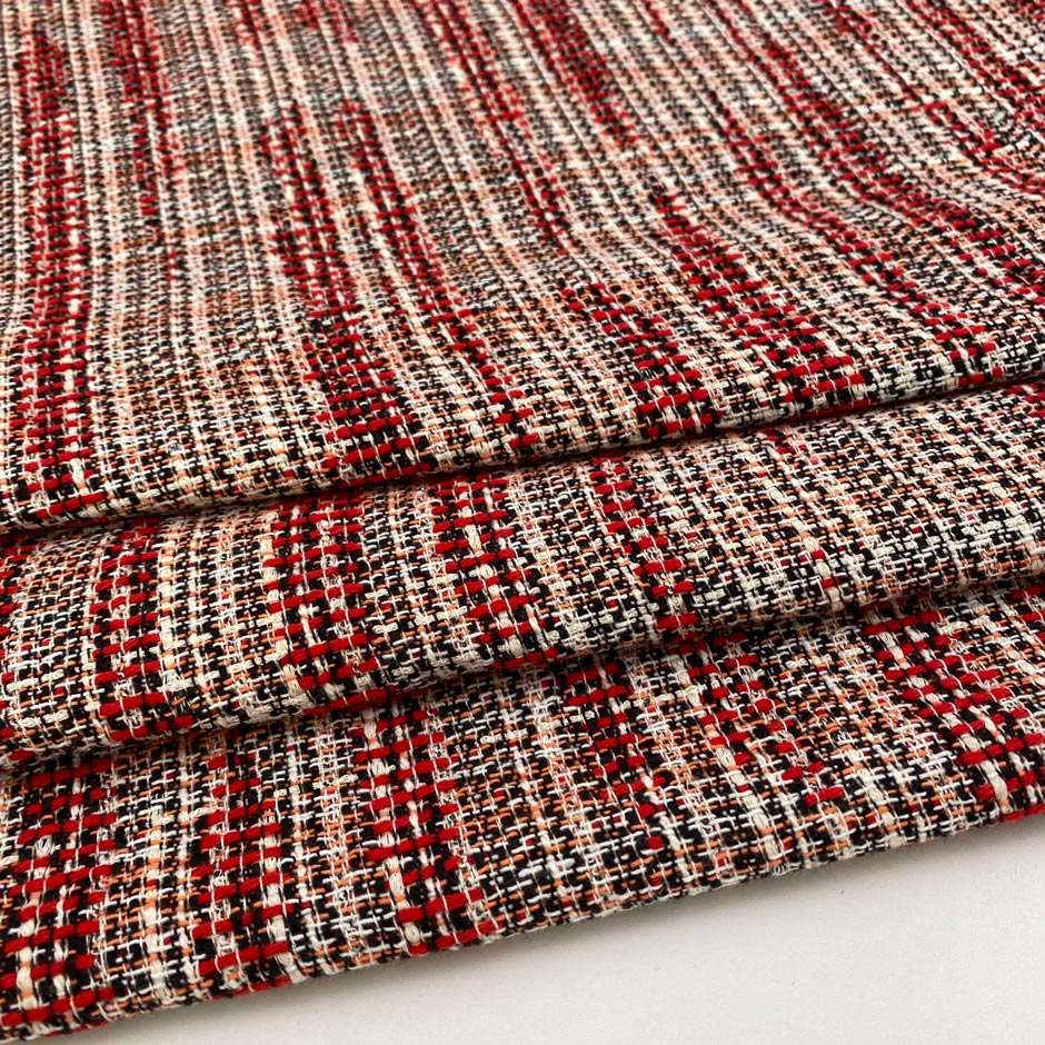 Red, black, orange and white cotton blend tweed. The fabric feels droopy and heavy. High quality deadstock fabric.&nbsp;