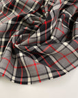 Falling and textured virgin wool tartan. High quality deadstock fabric.