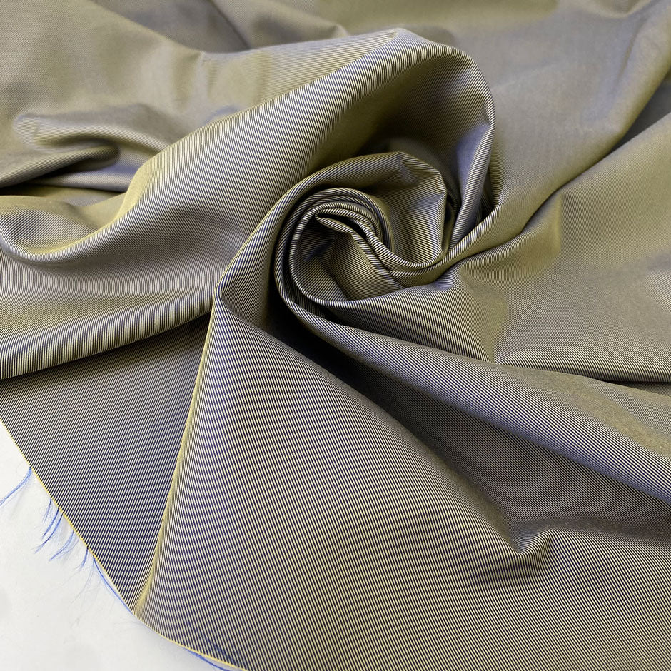 Mixed cotton and polyester denim with diagonal texture in a blend of sage green and bright blue. Medium weight, ideal for trench coats and jackets. High-quality deadstock collected in Stock from a Maison de Couture in Italy.