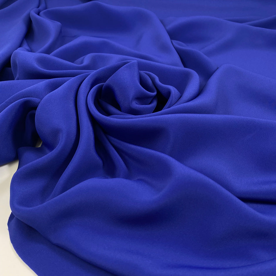 Falling acetate and silk crepe de chine in elettric blue. High-quality deadstock fabric by the meter collected in Stock from a Maison de Couture in Italy.