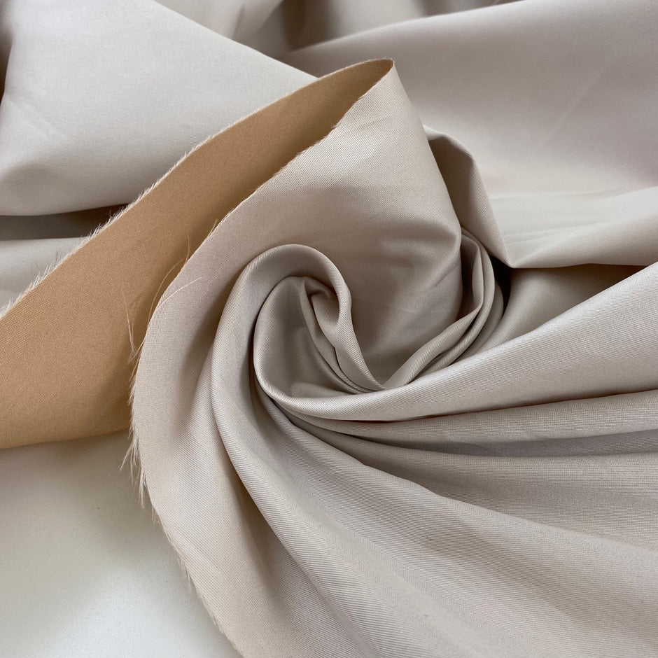 Double-face mikado in polyester and silk with pale rose tones, structured and elegant, ideal for dresses, skirts, and formal jackets. High-quality deadstock collected in Stock from a Maison de Couture in Italy.