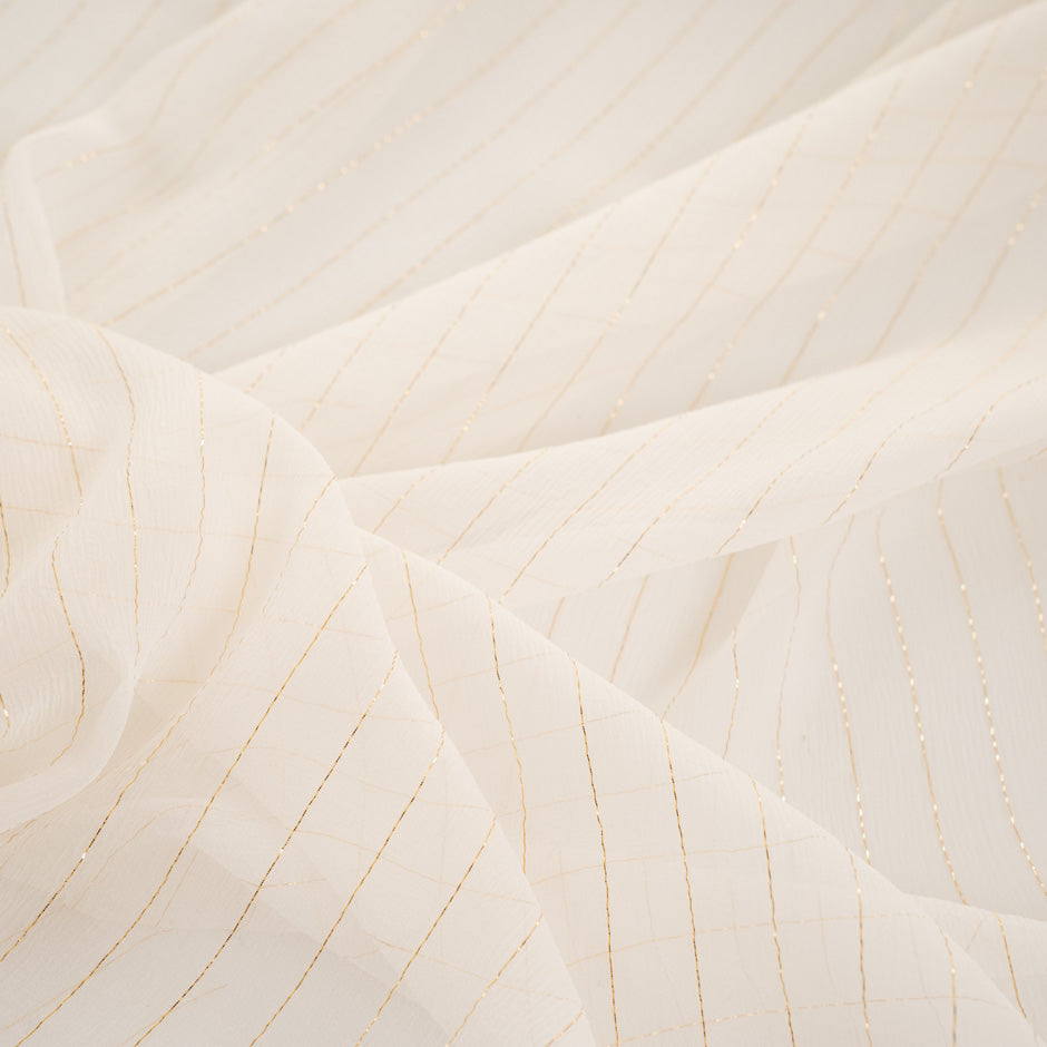White silk fabric with gold stripes, very light and trasparent. High quality deadstock fabric.