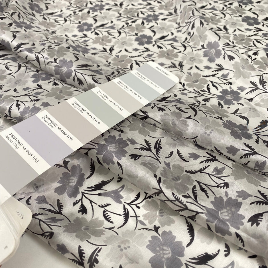 Pure silk with white ground and the flower design is in shades of gray. Very light, soft and semitrasparent. High-quality deadstock fabric collected in Stock from a Maison de Couture in Italy.