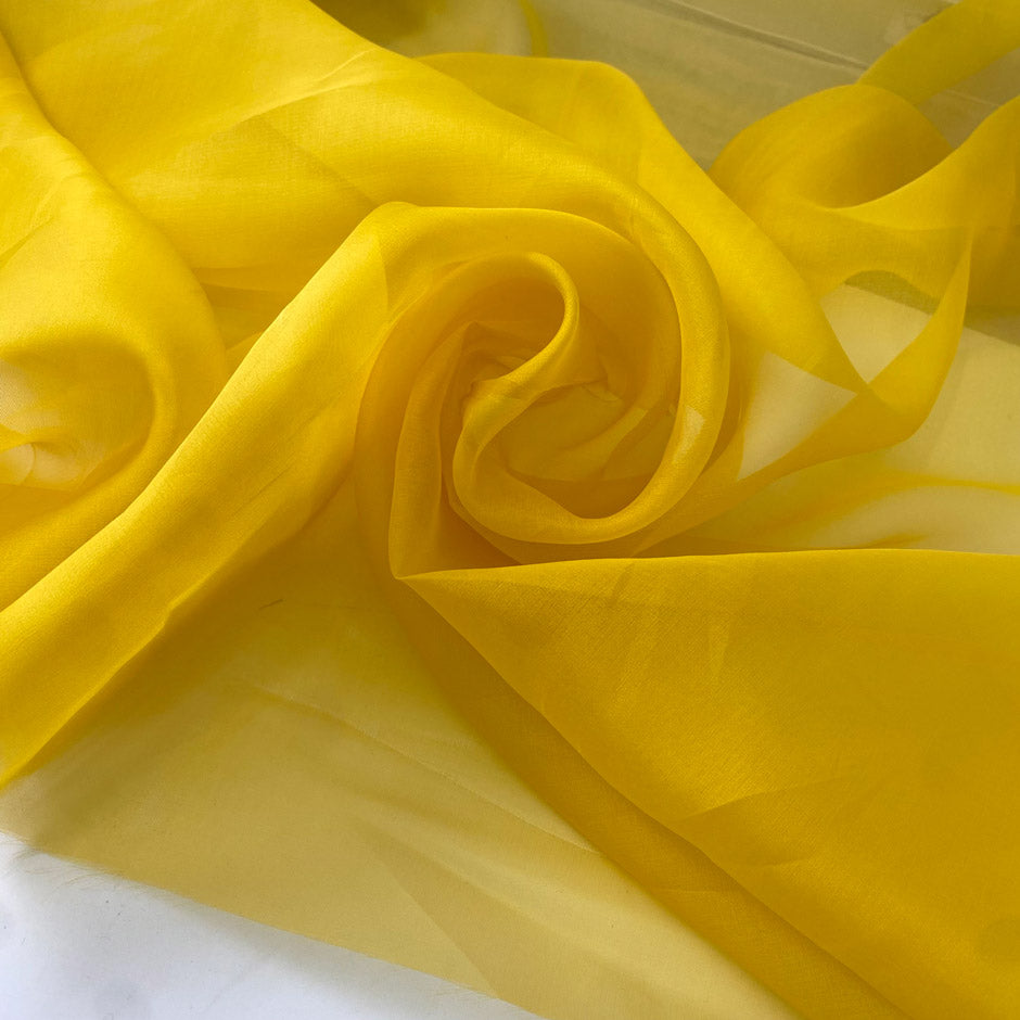Crisp and luminous yellow pure silk organza. Adds volume and holds shape beautifully. Ideal for shirting, blouses, dresses, and structured skirts.High-quality deadstock collected in Stock from a Maison de Couture in Italy.