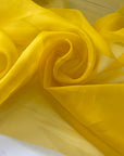 Crisp and luminous yellow pure silk organza. Adds volume and holds shape beautifully. Ideal for shirting, blouses, dresses, and structured skirts.High-quality deadstock collected in Stock from a Maison de Couture in Italy.