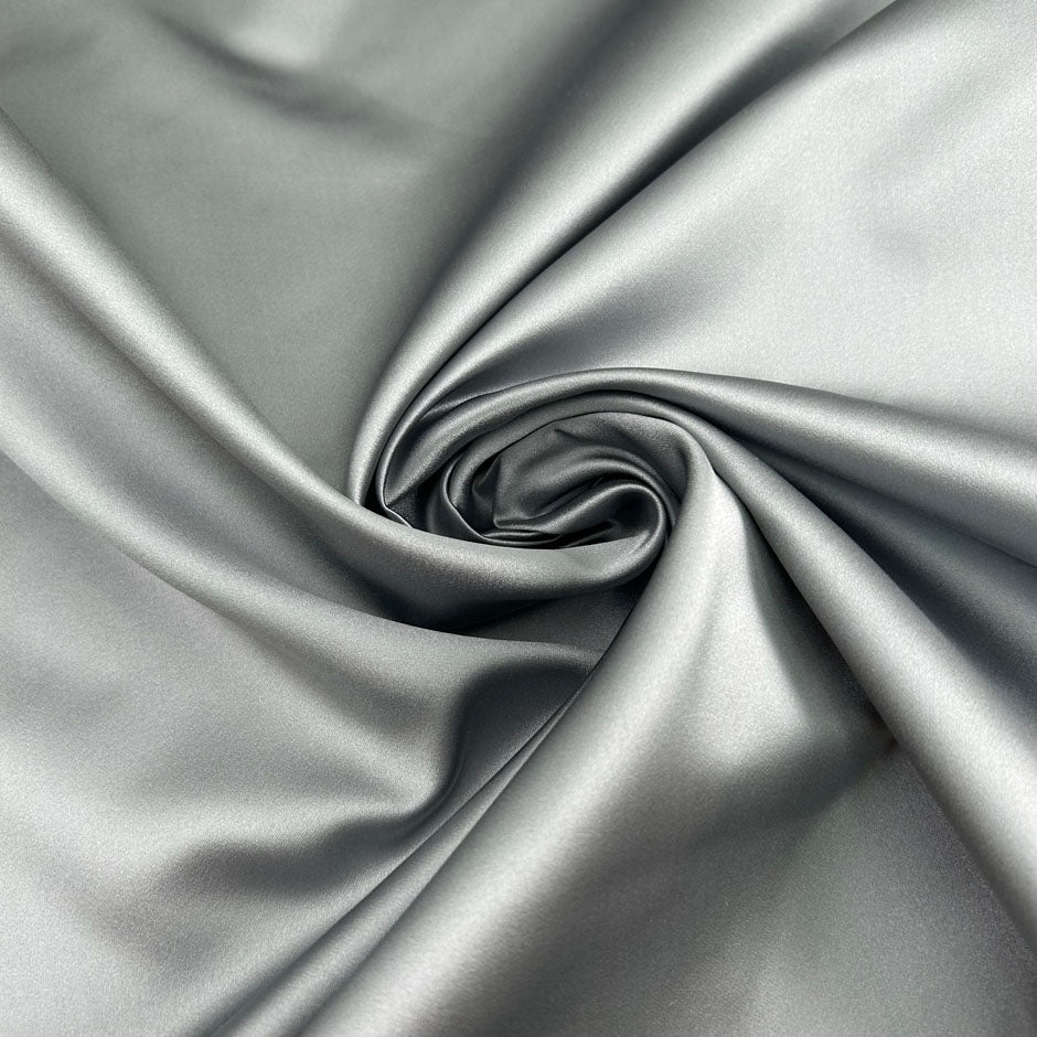 Silver pure silk duchesse satin, structured, lustrous and non-stretch. Perfect for skirts. High-quality deadstock collected in Stock from a Maison de Couture in Italy.