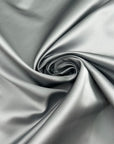 Silver pure silk duchesse satin, structured, lustrous and non-stretch. Perfect for skirts. High-quality deadstock collected in Stock from a Maison de Couture in Italy.
