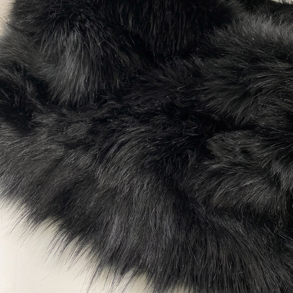 Eco fur in black with long hair, very soft and a little shiny. High-quality deadstock fabric by the meter collected in Stock from a Maison de Couture in Italy.