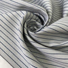 Heavy taffeta in a mix of polyester, silk, and cotton. Gray ground with blue stripes, heavy and stiff. Ideal for structured jackets, dresses, or skirts. High-quality deadstock collected in Stock from a Maison de Couture in Italy.