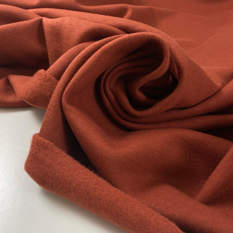 Cotton and elastane sweatshirt in rust color. Very soft and warm, ideal for sweaters, trousers, and jackets. High-quality deadstock fabric by the meter collected in Stock from a Maison de Couture in Italy.
