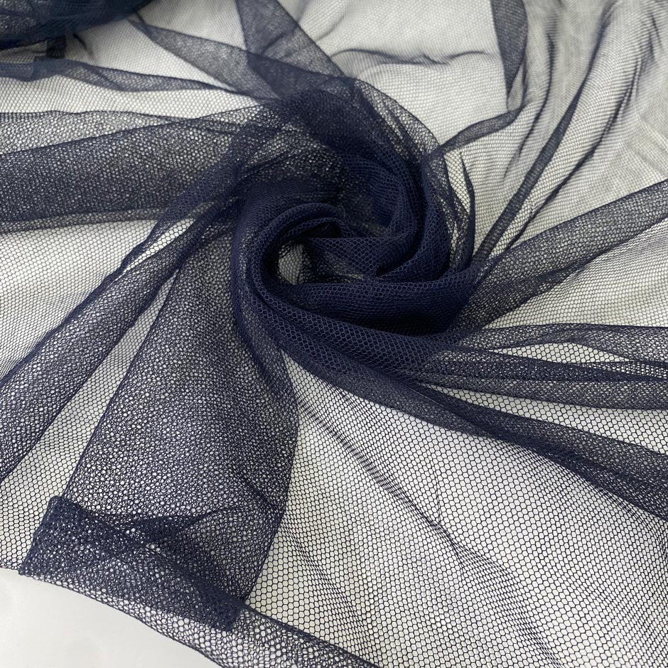 Cotton and polyester tulle in navy blue. Very light and soft, ideal for dresses and skirts. High-quality deadstock collected in Stock from a Maison de Couture in Italy.