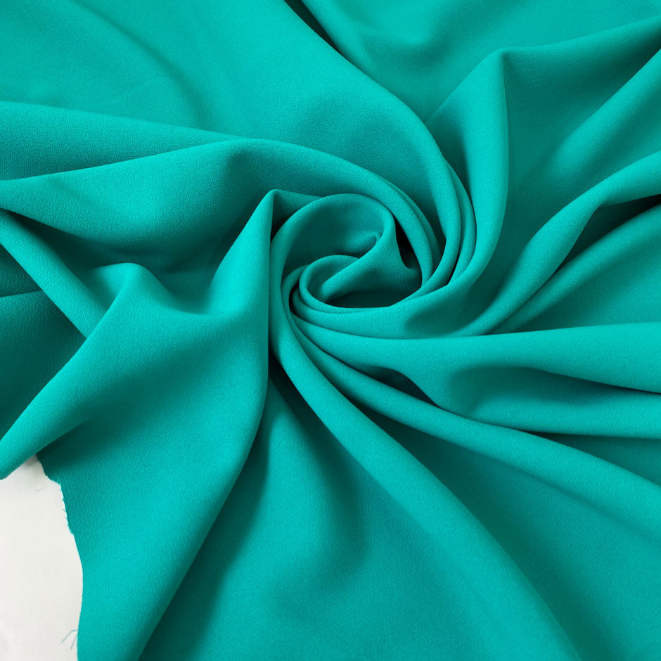Flowy and soft cady in turquoise with a crepe texture. Made from polyester and elastane, ideal for dresses, trousers, skirts, and light jackets.High-quality deadstock collected in Stock from a Maison de Couture in Italy.