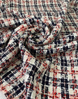 Cotton tweed with a white ground and check design in the shades of dark blue and red. Very soft and light. Ideal for jackets, skirts, and dresses. High-quality deadstock collected in Stock from a Maison de Couture in Italy.