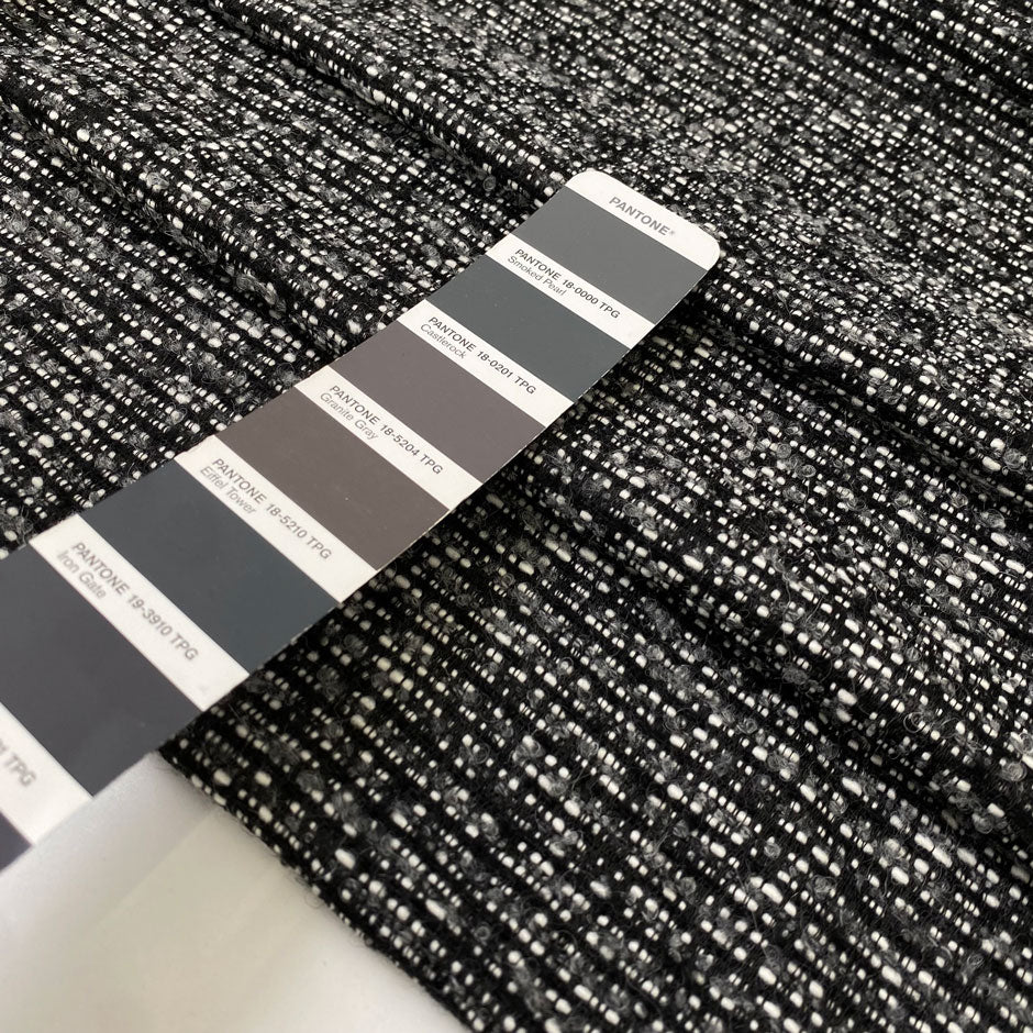 Tweed in polyester wool and viscose blend in smoked pearl grey. Very soft, light, warm and flowy. Ideal for winter dresses, jackets, skirts and light coats. High-quality deadstock collected in Stock from a Maison de Couture in Italy.