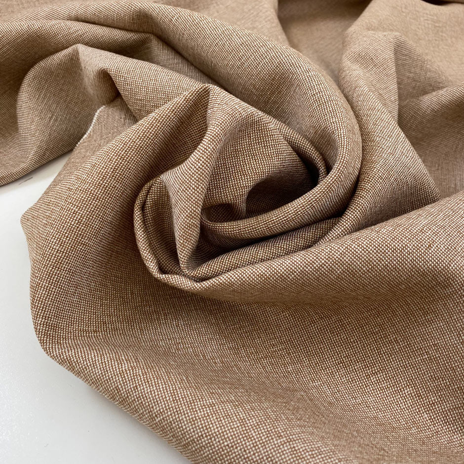 Pure wool light tweed in a tan brown melange. Very soft, medium weight, and not transparent. Ideal for jackets, skirts, or trousers. High-quality deadstock collected in Stock from a Maison de Couture in Italy.
