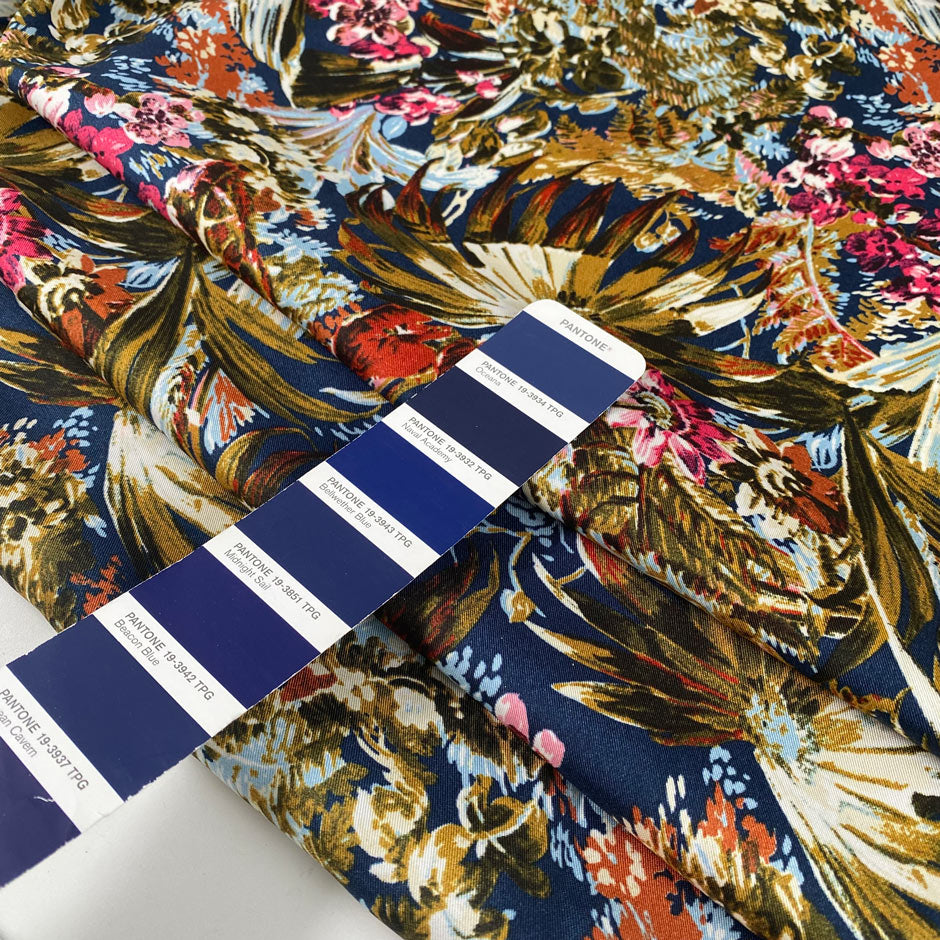 Multicolor polyester twill with beautiful floral design. In dark blue background and red, green, pink, light blue and white shades. Very light high-quality deadstock fabric by the meter collected in Stock from a Maison de Couture in Italy.