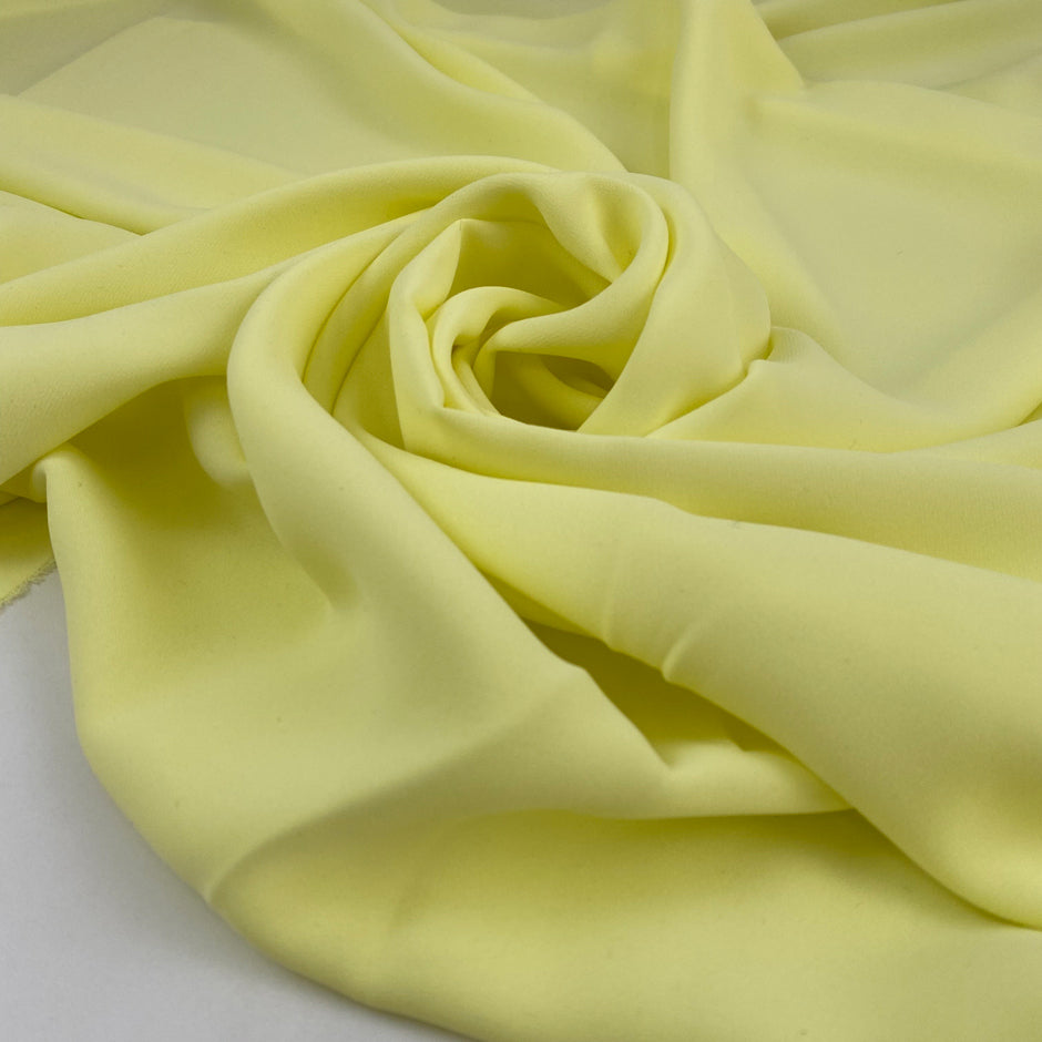 Polyester ligh cady in very bright yellow, very soft, flowy, not transparent. High-quality deadstock fabric collected in Stock from a Maison de Couture in Italy.