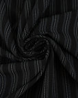 Fabric in black chalk stripe with fine white lines, elegant and slightly structured. Ideal for tailoring, trousers, jackets and skirts. High-quality deadstock collected in Stock from a Maison de Couture in Italy.