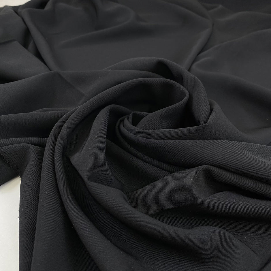 Light cady in black polyester very soft and light. High-quality deadstock fabric collected in Stock from a Maison de Couture in Italy.