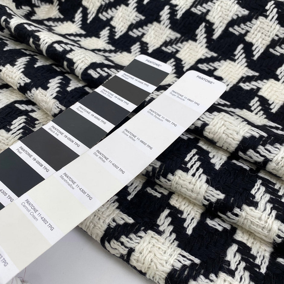 Pure wool with pied de poule design in black and white, color reference Pirate Black and Marshmallow. Heavy and structured, ideal for coats and jackets. High-quality deadstock collected in Stock from a Maison de Couture in Italy.