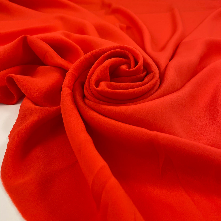 Crepe de chine in acetate and silk, very soft and light, in lobster orange. High-quality deadstock fabric by the meter collected in Stock from a Maison de Couture in Italy.