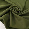Dark green stretch Punto Milano jersey in polyester and elastane in the shade avocado, slightly heavy and stiff, with a rough texture. Ideal for trousers, skirts, dresses and jackets. High-quality deadstock collected in Stock from a Maison de Couture in Italy.