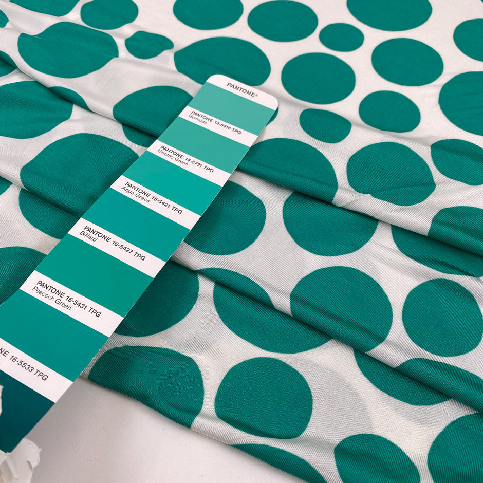 Pure viscose jersey with big green Pois dots on a white background. very soft, stretch, and light. High-quality deadstock fabric collected in Stock from a Maison de Couture in Italy.