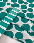 Pure viscose jersey with big green Pois dots on a white background. very soft, stretch, and light. High-quality deadstock fabric collected in Stock from a Maison de Couture in Italy.