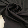 Heavy punto Milano jersey, pure viscose, a little stretch, very flowy in Pirate Black. Ideal for dresses, skirts, and trousers. High-quality deadstock fabric by the meter collected in Stock from a Maison de Couture in Italy.