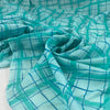 Soft, light, and transparent pure cotton batiste with check design in turquoise and blue shades. High-quality deadstock fabric collected in Stock from a Maison de Couture in Italy.