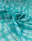 Soft, light, and transparent pure cotton batiste with check design in turquoise and blue shades. High-quality deadstock fabric collected in Stock from a Maison de Couture in Italy.