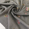Warm polyester Prince of Wales in black and white with delicate floral embroidery. Ideal for trousers, jackets, dresses, and skirts.High-quality deadstock collected in Stock from a Maison de Couture in Italy.