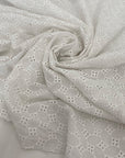 Pure cotton in bright white with geometric square embroidery. Very soft, light, and slightly transparent. Perfect for shirting, dresses, and skirts. High-quality deadstock collected in Stock from a Maison de Couture in Italy.