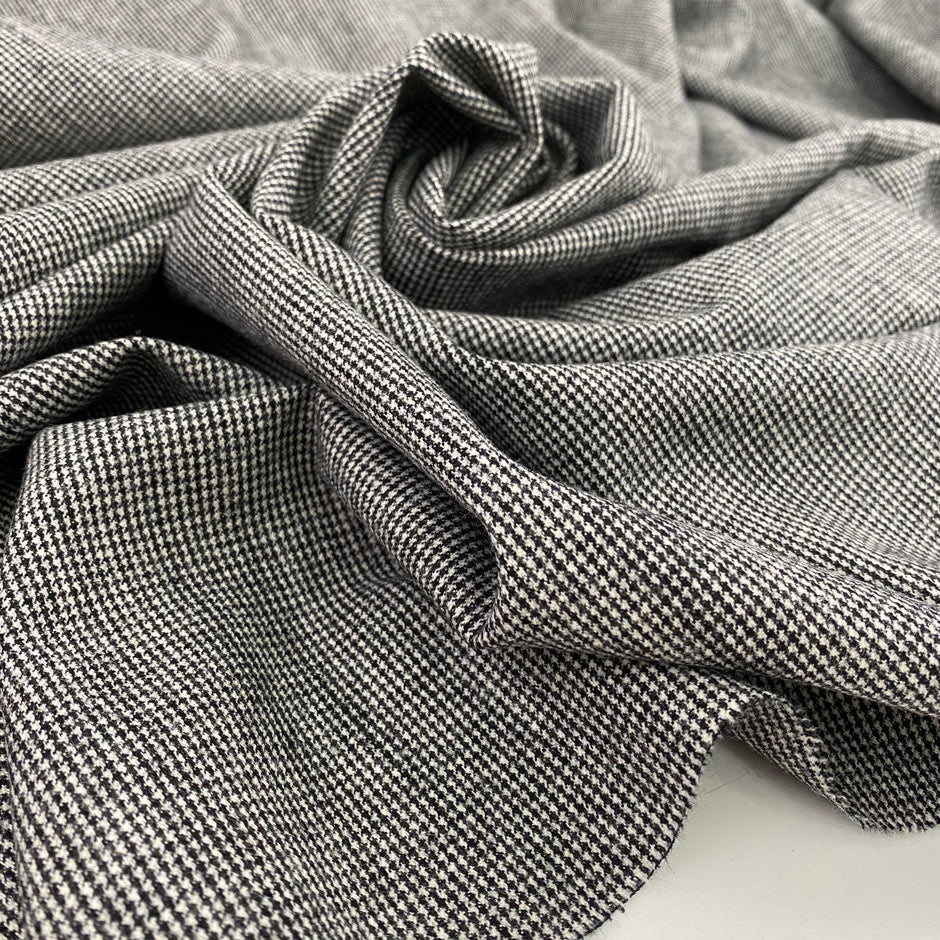 Light, white and pure wool fabric with black wires. High-quality deadstock fabric collected in Stock from a Maison de Couture in Italy.