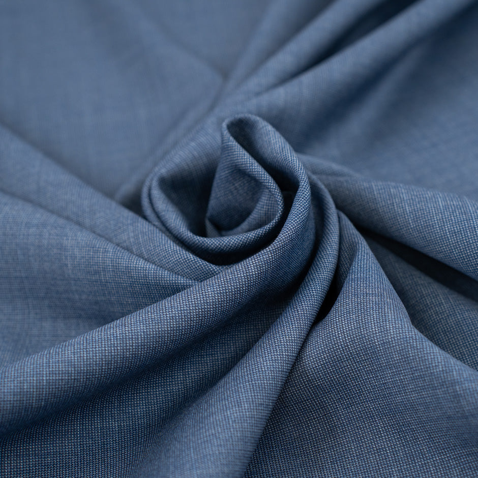 Pure light blue wool with white wires. The fabric is falling and soft. High-quality deadstock fabric collected in Stock from a Maison de Couture in Italy.