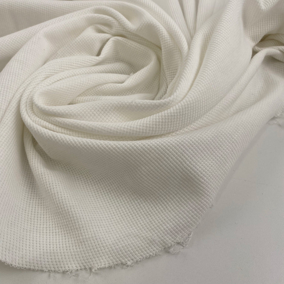 Pure white cotton jersey, stretchy and semi-trasparent. High quality deadstock fabric.