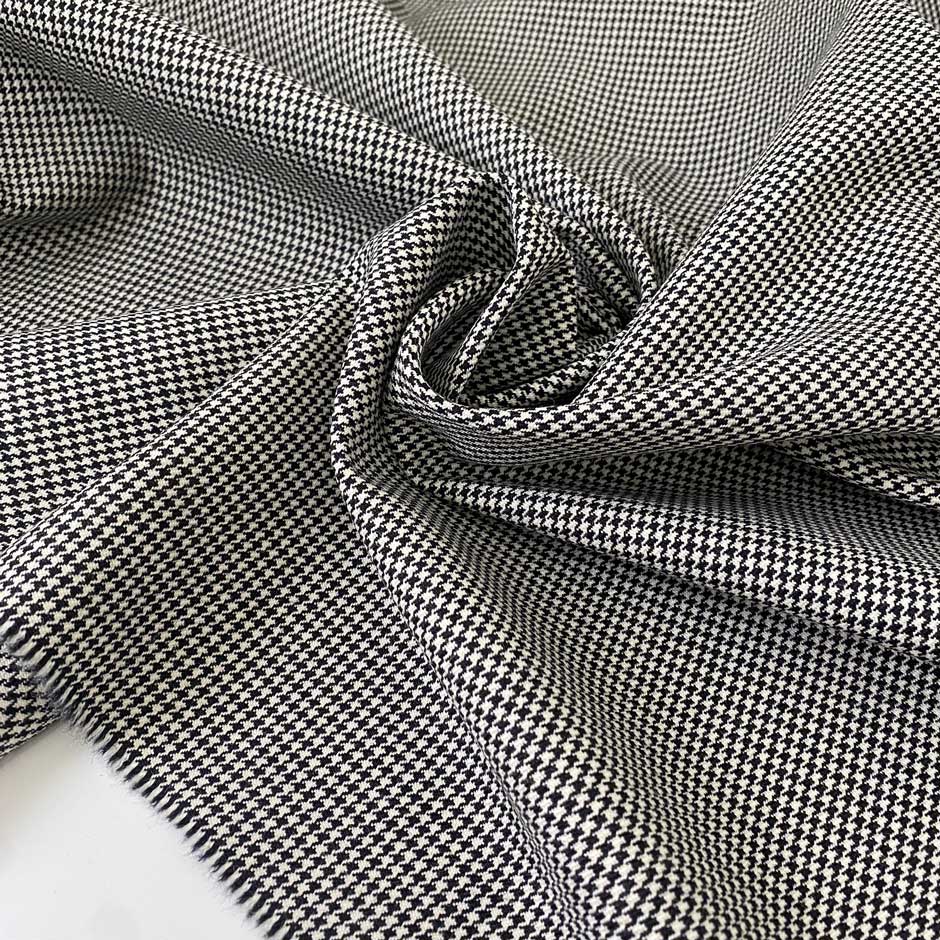 Pure wool with a pied de poule design in the shades of antique white and black sand. Stiff and rough, ideal for coats, jackets, and structured skirts. High-quality deadstock collected in Stock from a Maison de Couture in Italy.